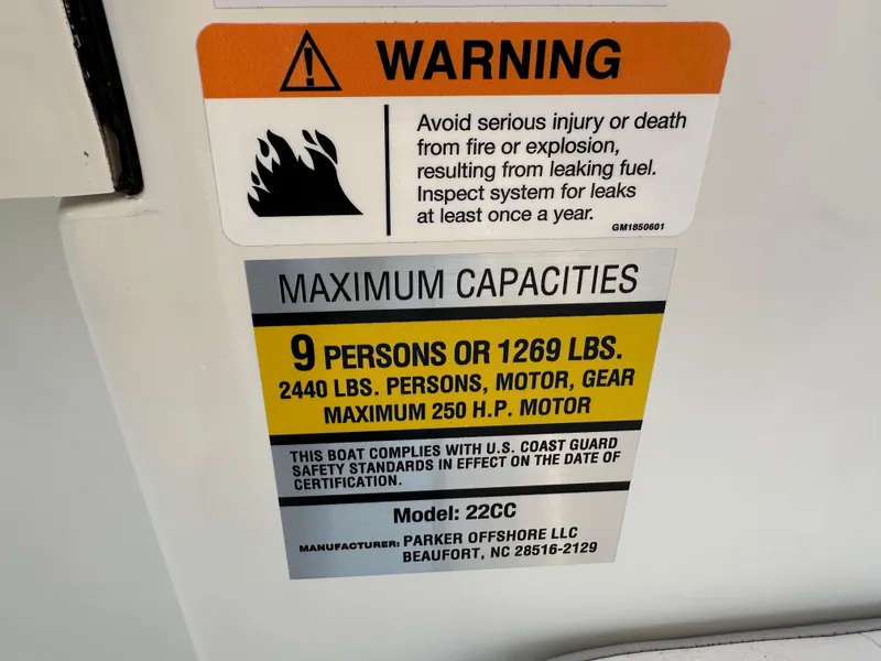 Slide: The Image of Warning label on 2025 Parker 2200 CC boat detailing maximum capacities and safety standards. - 11