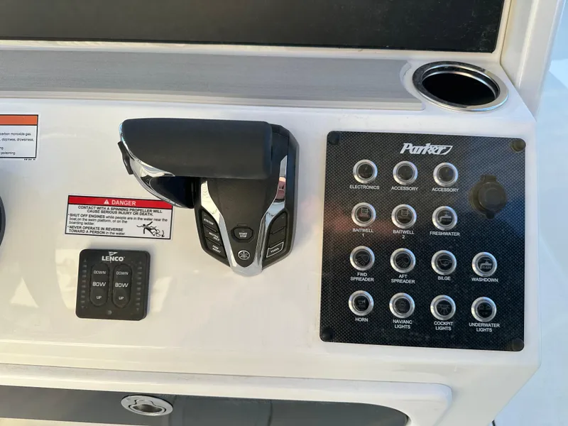 Slide: The Image of Control panel of a 2025 Parker 2200 CC boat with switches and throttle. - 13