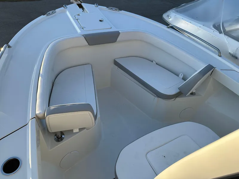 Slide: The Image of 2025 Parker 2200 CC boat interior with white cushioned seating. - 17