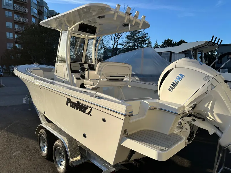 Slide: The Image of 2025 Parker 2200 CC boat with Yamaha engine, parked on a trailer in a marina. - 3