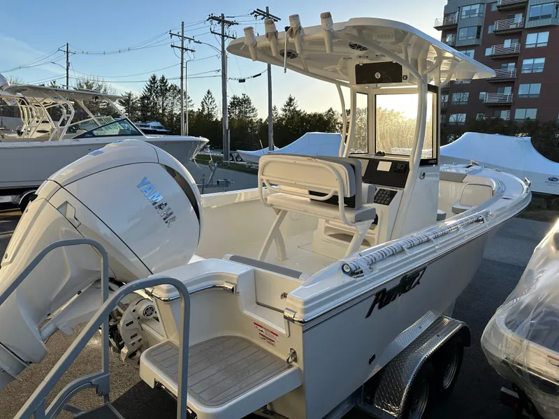 Slide: The Image of 2025 Parker 2200 CC boat with Yamaha outboard engine, parked on a trailer. - 4