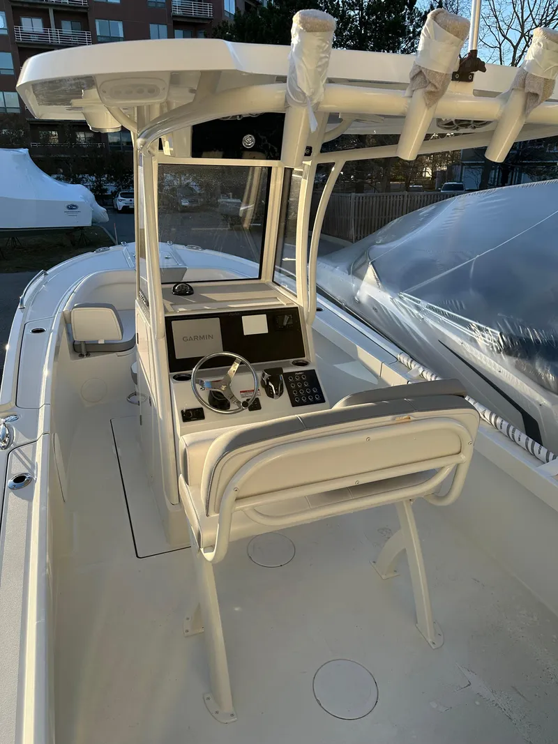 Slide: The Image of 2025 Parker 2200 CC boat interior with modern console and seating. - 7