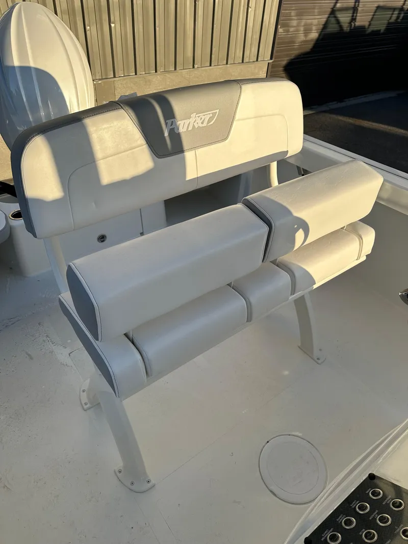 Slide: The Image of 2025 Parker 2200 CC boat seating with cushioned backrest and armrests. - 9