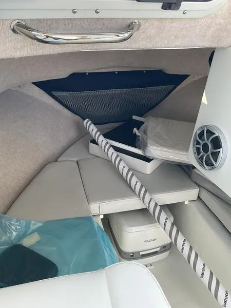 Slide: The Image of Interior of 2025 Parker 2120 Sport Cabin boat, featuring seating and storage. - 9