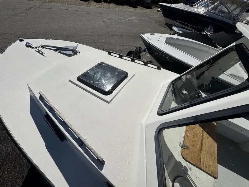 Slide: The Image of 1996 Eastern 27 Lobster Fisherman boat, white deck, docked with other boats. - 10