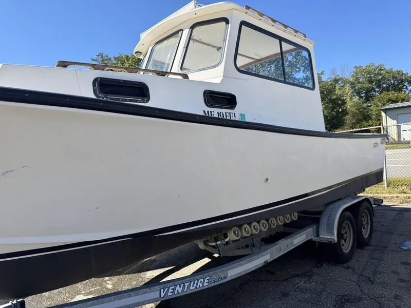 Slide: The Image of 1996 Eastern 27 Lobster Fisherman boat on trailer, white hull, outdoor setting. - 14