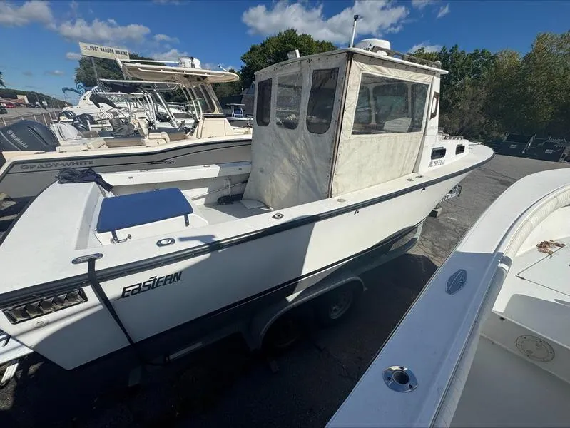 Slide: The Image of 1996 Eastern 27 Lobster Fisherman boat on trailer, parked outdoors under blue sky. - 16