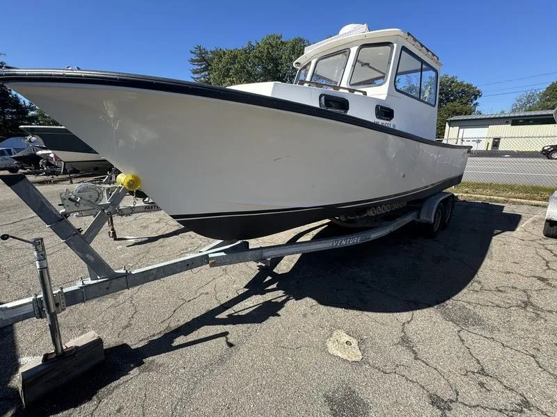 Slide: The Image of 1996 Eastern 27 Lobster Fisherman boat on trailer, parked outdoors. - 2