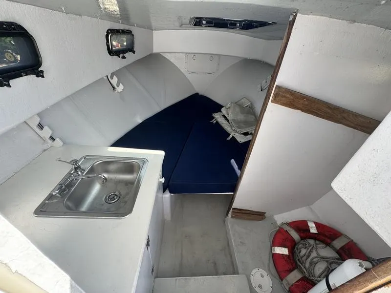 Slide: The Image of Interior of 1996 Eastern 27 Lobster Fisherman boat with sink, seating, and life preserver. - 5
