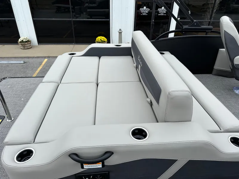 Slide: The Image of 2025 Barletta C24UC boat interior with gray seating and cup holders. - 11