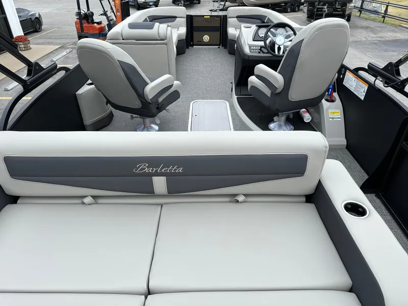 Slide: The Image of 2025 Barletta C24UC boat interior with luxurious seating and modern dashboard. - 12