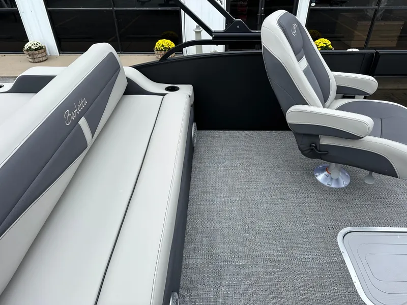 Slide: The Image of 2025 Barletta C24UC boat interior with gray seating and carpet flooring. - 13