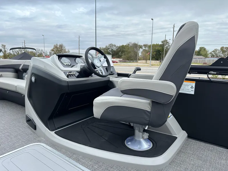 Slide: The Image of 2025 Barletta C24UC boat interior with captain's chair and steering console. - 15
