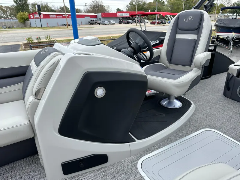 Slide: The Image of 2025 Barletta C24UC boat interior with modern seating and steering console. - 16