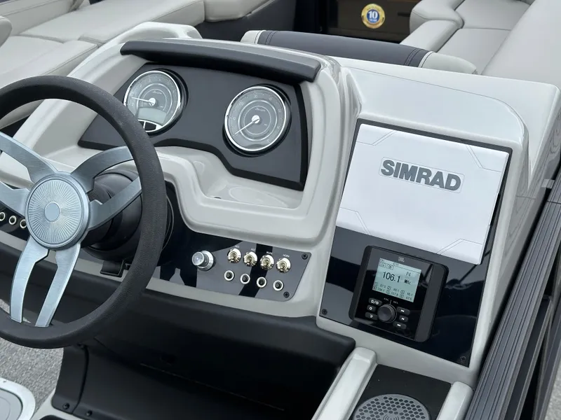 Slide: The Image of Barletta C24UC 2025 boat dashboard with Simrad navigation system and modern controls. - 19