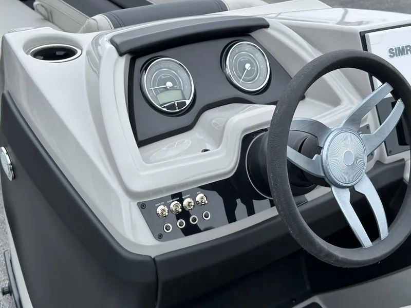 Slide: The Image of 2025 Barletta C24UC boat dashboard with steering wheel and gauges. - 20