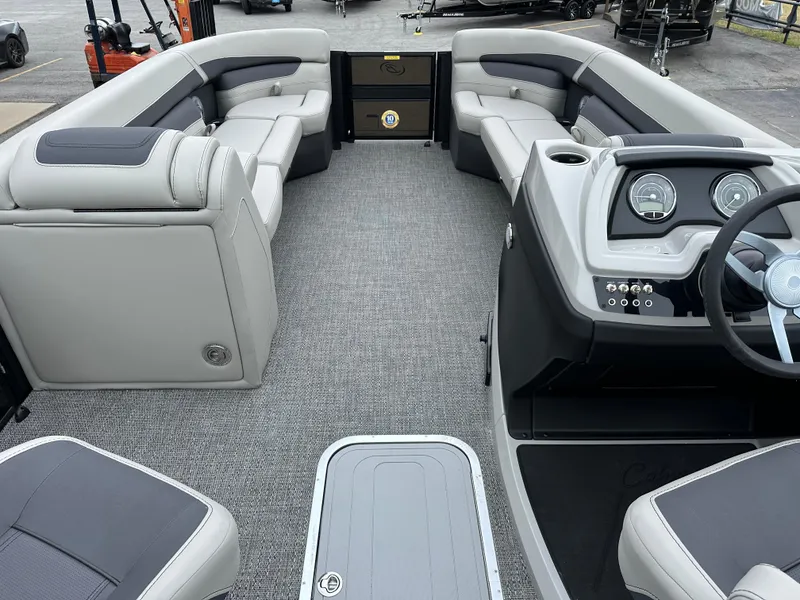 Slide: The Image of 2025 Barletta C24UC pontoon boat interior with plush seating and modern dashboard. - 21
