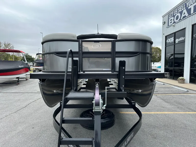 Slide: The Image of 2025 Barletta C24UC pontoon boat on trailer at dealership. - 4