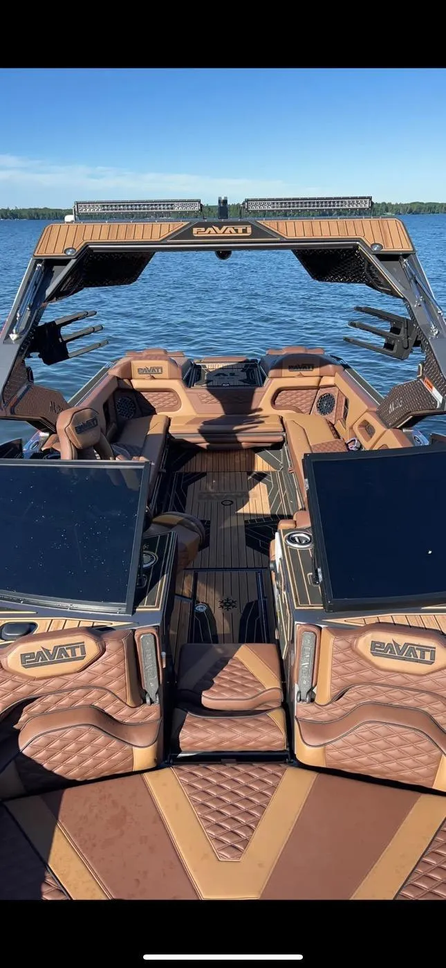 Slide: The Image of 2022 Pavati AL26 boat interior with luxurious seating on a calm lake. - 1