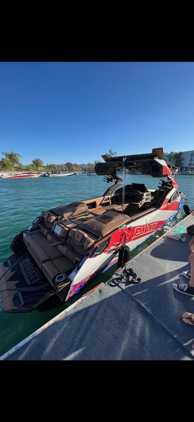 Slide: The Image of 2022 Pavati AL26 boat docked on a sunny day, featuring sleek design and vibrant colors. - 4