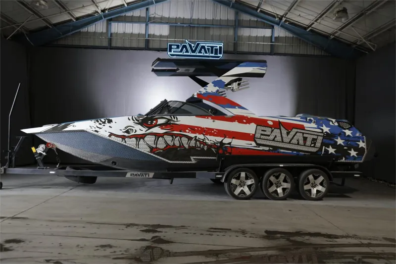 Slide: The Image of 2017 Pavati AL26 boat with American flag design in a showroom. - 0