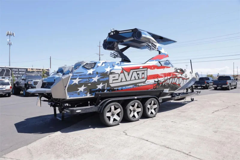 Slide: The Image of 2017 Pavati AL26 boat with American flag design on a trailer. - 2
