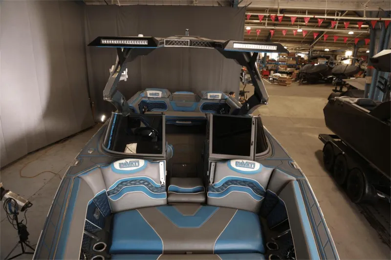 Slide: The Image of 2017 Pavati AL26 boat interior with blue and gray seating in a warehouse setting. - 3