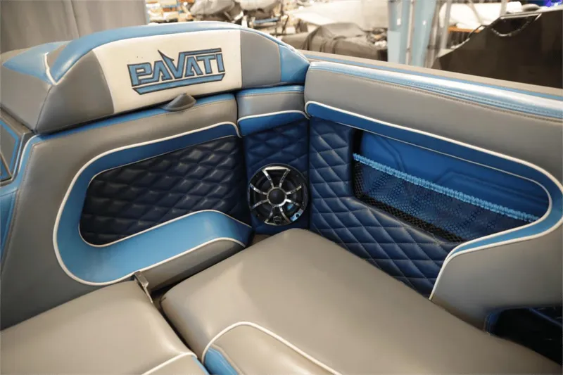 Slide: The Image of 2017 Pavati AL26 boat interior with blue and gray quilted seats and speaker. - 4