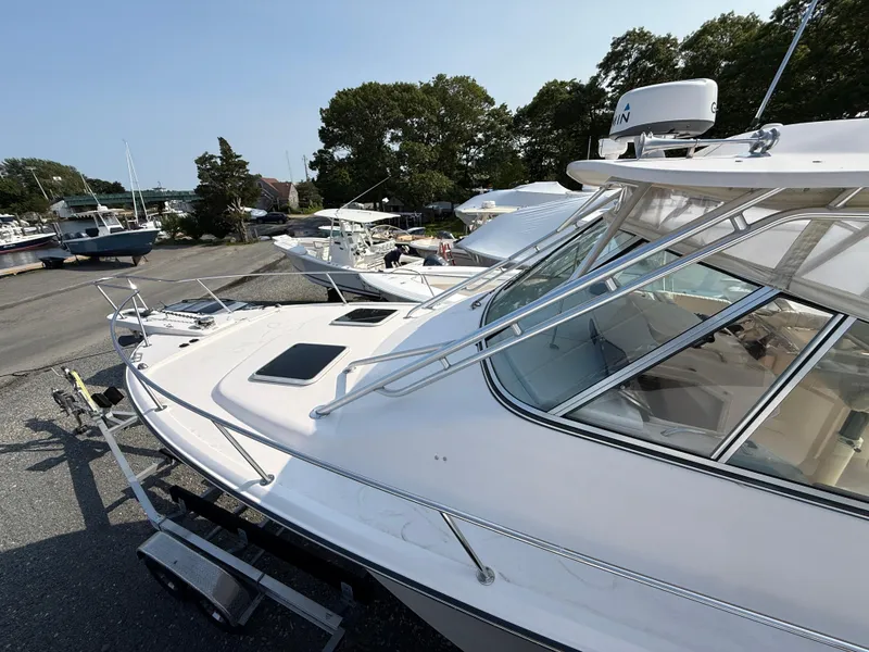 Slide: The Image of 2008 Grady-White 330 Express boat docked, showcasing sleek design and spacious deck. - 21
