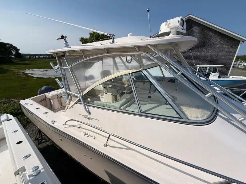 Slide: The Image of 2008 Grady-White 330 Express boat docked, showcasing sleek design and spacious cabin. - 22
