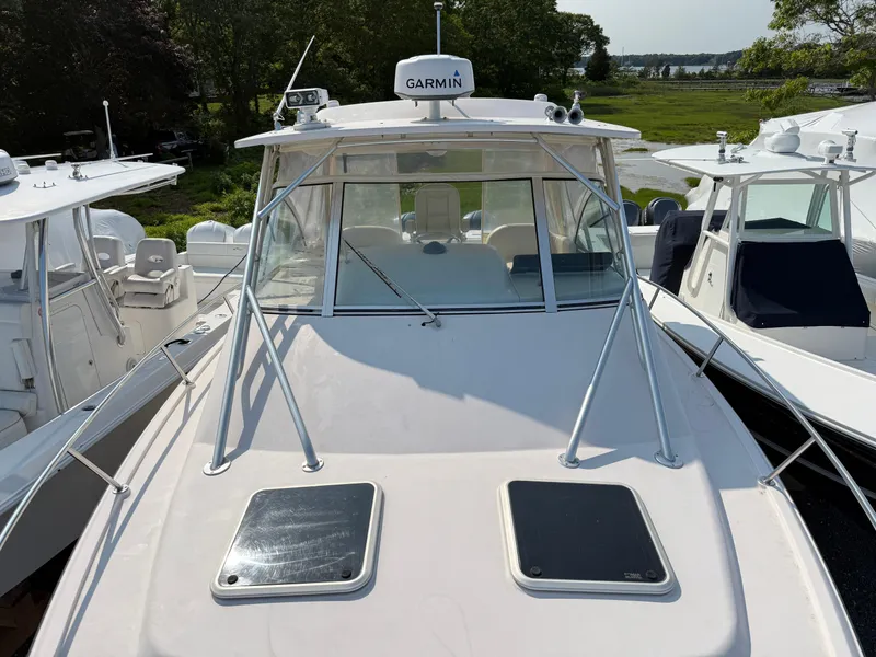 Slide: The Image of 2008 Grady-White 330 Express boat with Garmin equipment, docked among other boats. - 25