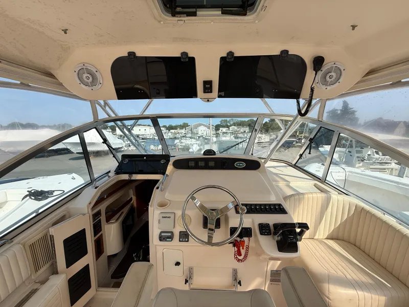 Slide: The Image of 2008 Grady-White 330 Express boat cockpit with steering wheel and navigation controls. - 37