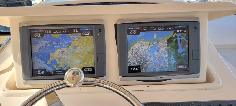 Slide: The Image of Navigation screens on a 2008 Grady-White 330 Express boat dashboard. - 4