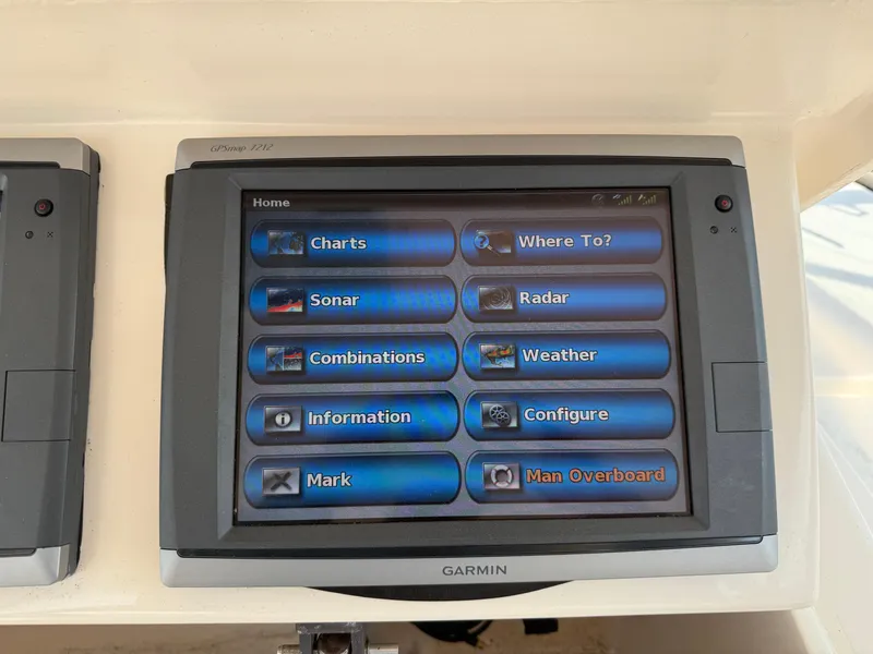 Slide: The Image of Garmin GPS display on 2008 Grady-White 330 Express boat showing navigation options. - 42