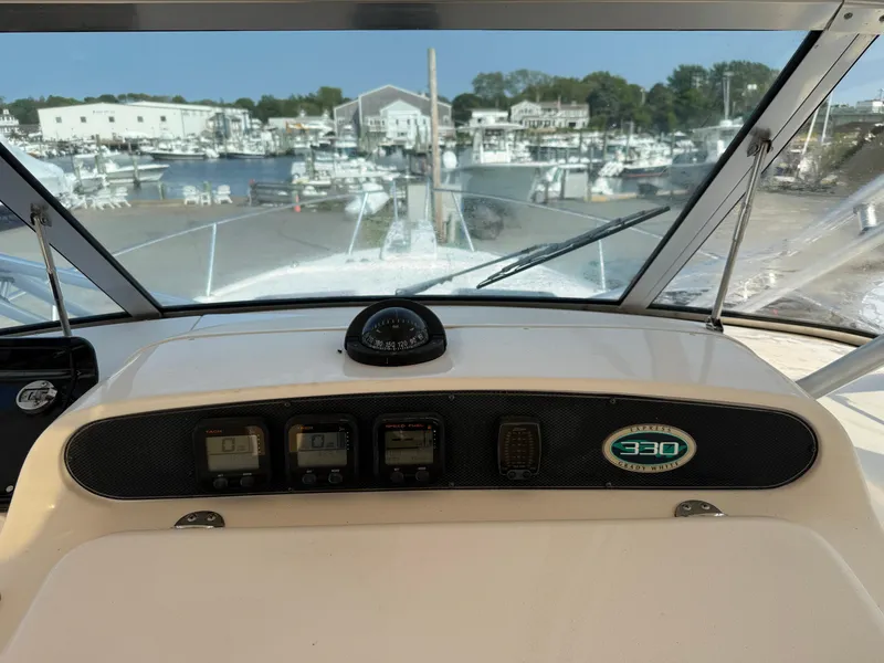 Slide: The Image of 2008 Grady-White 330 Express boat dashboard with marina view in background. - 46