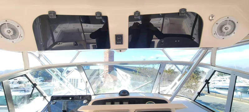 Slide: The Image of Interior view of 2008 Grady-White 330 Express boat cockpit with clear windows and speakers. - 7