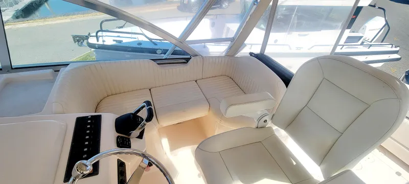 Slide: The Image of 2008 Grady-White 330 Express boat interior with white seating and steering wheel. - 8