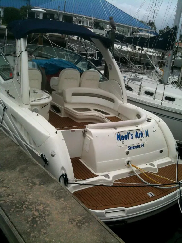 Slide: The Image of 2006 Sea Ray Sundancer yacht docked, featuring spacious seating and elegant design. - 0