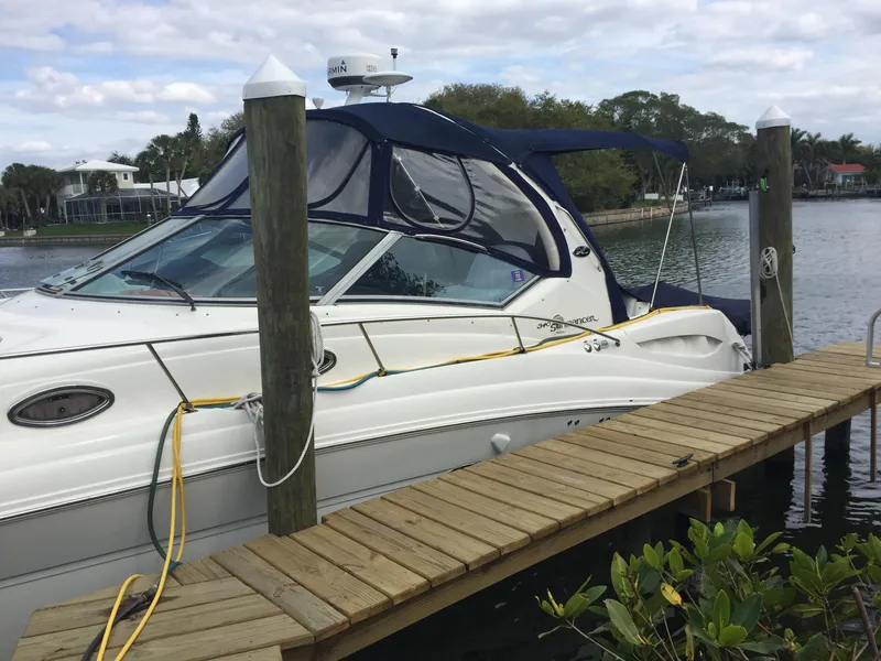 Slide: The Image of 2006 Sea Ray Sundancer docked by a wooden pier on a calm waterway. - 1