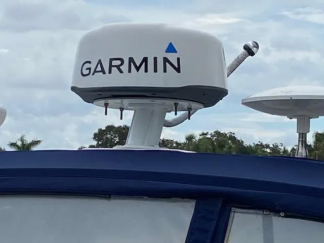 Slide: The Image of Garmin radar on 2006 Sea Ray Sundancer boat against cloudy sky. - 14