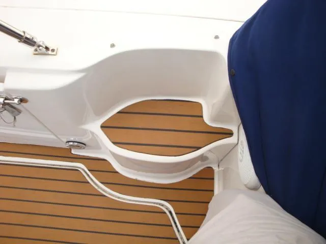 Slide: The Image of Interior view of 2006 Sea Ray Sundancer boat with teak flooring and white seating. - 16