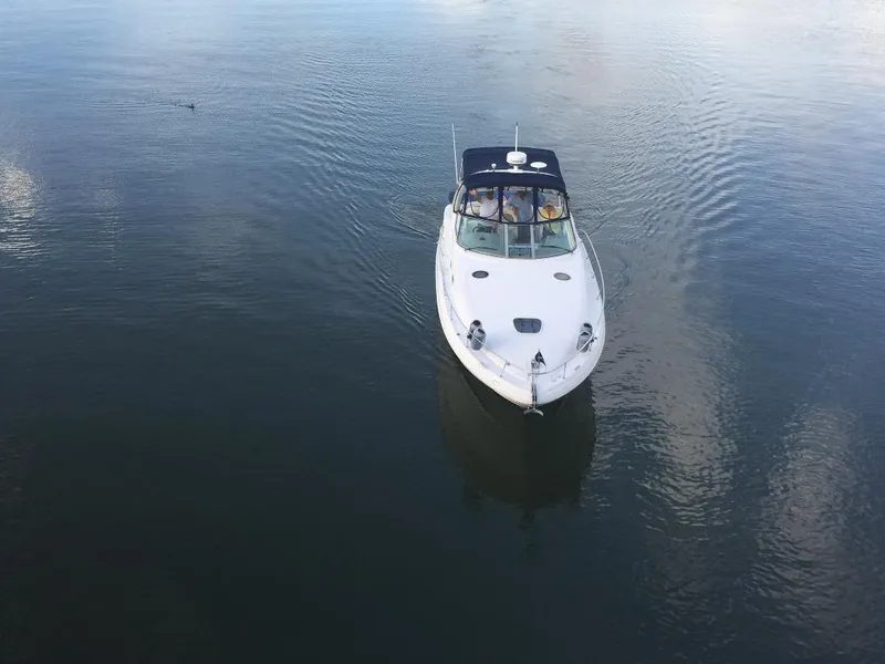 Slide: The Image of 2006 Sea Ray Sundancer boat cruising on calm water. - 17