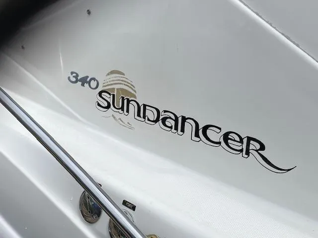 Slide: The Image of 2006 Sea Ray Sundancer 340 boat logo on white hull. - 2