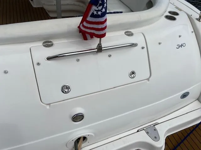 Slide: The Image of 2006 Sea Ray Sundancer 340 boat stern with American flag and storage compartment. - 22