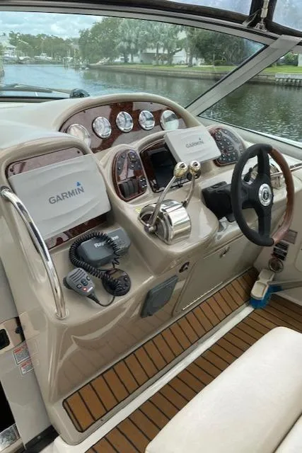 Slide: The Image of 2006 Sea Ray Sundancer helm with Garmin navigation, wood accents, and modern controls. - 25