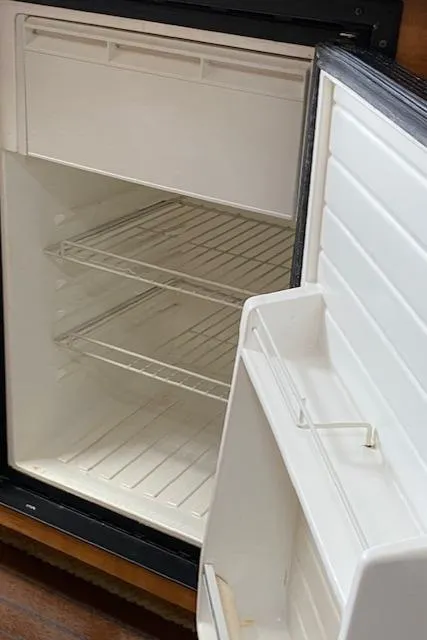 Slide: The Image of Empty refrigerator inside 2006 Sea Ray Sundancer boat. - 28