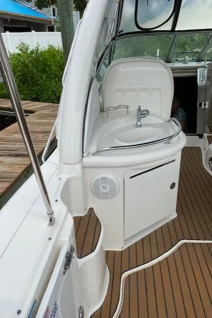 Slide: The Image of 2006 Sea Ray Sundancer boat interior with sink and wooden deck. - 34