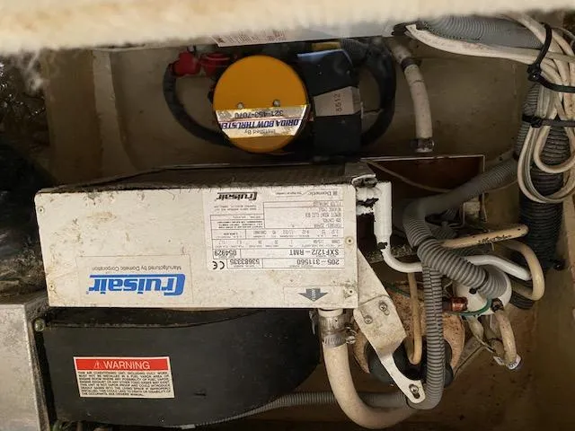 Slide: The Image of Engine compartment of a 2006 Sea Ray Sundancer with wiring and components visible. - 4