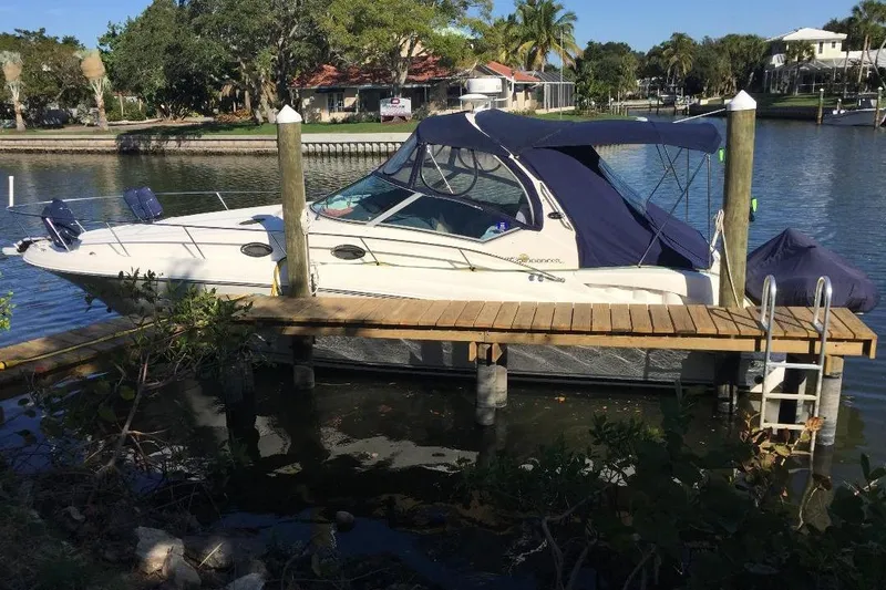Slide: The Image of 2006 Sea Ray Sundancer docked by a scenic waterfront. - 40