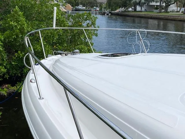 Slide: The Image of 2006 Sea Ray Sundancer boat docked by a scenic waterway. - 7